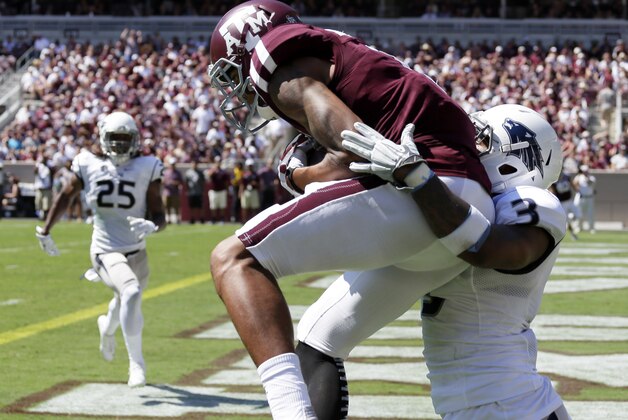 Texas A&M wide receiver Josh Reynolds, left, catches a pass for a touchdown as Nevada defensive back Ahki Muhammad (3) defends during the first half of an NCAA college football game Saturday, Sept. 19, 2015, in College Station, Texas. (AP Photo/David J. Phillip)