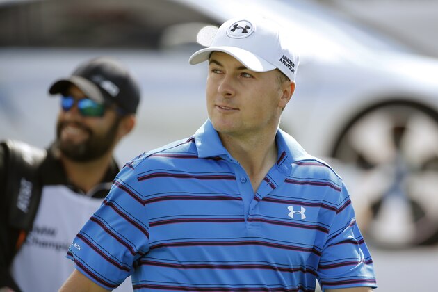 Jordan Spieth looks at a vocal fan in the stands after hitting his tee shot on the first hole during the third round of the BMW Championship golf tournament at Conway Farms Golf Club, Saturday, Sept. 19, 2015, in Lake Forest, Ill. (AP Photo/Charles Rex Arbogast)