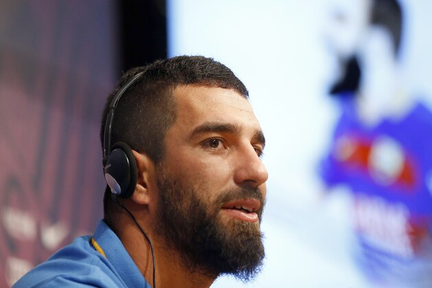 FC Barcelona's new signing Arda Turan speaks during a press conference of his official presentation at the Camp Nou stadium in Barcelona, Spain, Friday, July 10, 2015. The European champions announced a five-year deal for the 28-year-old Turkey midfielder. Barcelona made the signing despite currently being without a permanent president or executive board members, who resigned under club bylaws before elections on July 18. (AP Photo/Manu Fernandez)