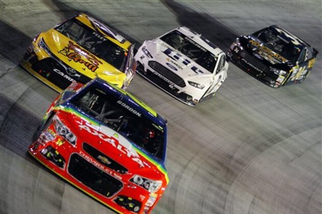Jeff Gordon (24) drives through a turn in fron tof JJ Yeley (23), Brad Keselowski (2) and Brett Moffitt (34) during the NASCAR Sprint Cup Series auto race, Saturday, Aug. 22, 2015, in Bristol, Tenn. (AP Photo/Wade Payne)