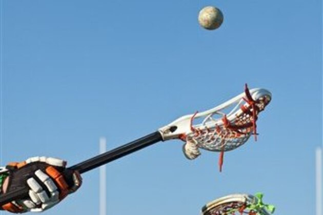 Lacrosse players competing for the ball (Image Source via AP Images)