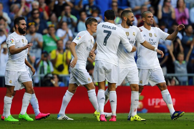 Real Madrid's Karim Benzema, third right, celebrates with teammates after scoring the opening goal against Granada during a Spanish La Liga soccer match between Real Madrid and Granada at the Santiago Bernabeu stadium in Madrid, Saturday, Sept. 19, 2015. Benzema scored once in Real Madrid's 1-0 victory. (AP Photo/Francisco Seco)