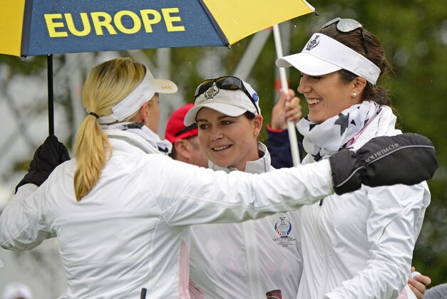 Europe's team captain Carin Koch of Sweden, left,  Caroline Masson of Germany, center, and Sandra Gal of Germany, right, celebrate during the fourballs on Day2 at the Solheim Cup golf tournament in St. Leon-Rot, southern Germany, Saturday, Sept. 19, 2015. (AP Photo/Jens Meyer)