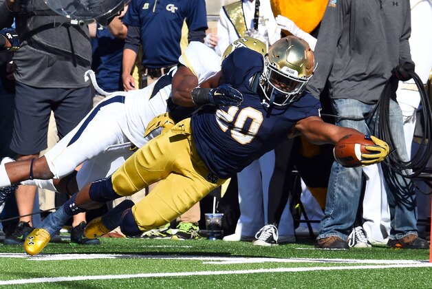 Sep 19, 2015; South Bend, IN, USA; Notre Dame Fighting Irish running back C.J. Prosise (20) makes a diving touchdown run against the Georgia Tech Yellow Jackets during the first half at Notre Dame Stadium. Mandatory Credit: Mike DiNovo-USA TODAY Sports