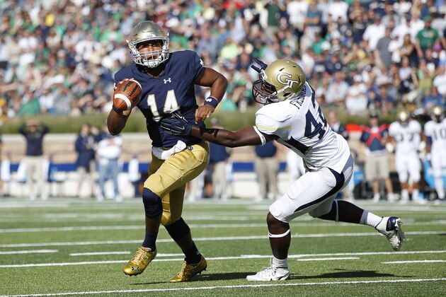 SOUTH BEND, IN - SEPTEMBER 19: DeShone Kizer #14 of the Notre Dame Fighting Irish looks to pass while under pressure from KeShun Freeman #42 of the Georgia Tech Yellow Jackets in the first half at Notre Dame Stadium on September 19, 2015 in South Bend, Indiana. Notre Dame defeated Georgia Tech 30-22. (Photo by Joe Robbins/Getty Images)