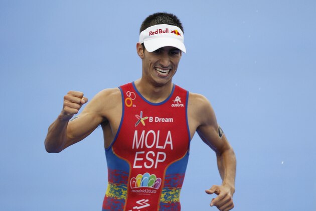 Mario Mola of Spain celebrates placing third in the elite men's race and third in the world series championship during the World Triathlon Grand Final in Hyde Park, London, Sunday, Sept. 15, 2013. (AP Photo/Sang Tan)
