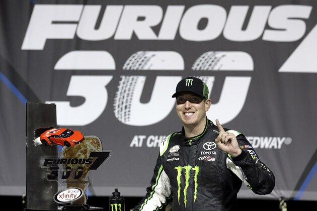 Kyle Busch poses with the trophy in Victory Lane after winning the NASCAR Xfinity series auto race at Chicagoland Speedway, Saturday, Sept. 19, 2015, in Joliet, Ill. This is his fourth victory and eighth top-10 finish in 12 races at Chicagoland Speedway. (AP Photo/Nam Y. Huh)