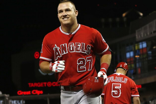 Los Angeles Angels’ Mike Trout smiles as he runs to the dugout after his solo home run off Minnesota Twins pitcher Ryan O'Rourke in the fourth inning of a baseball game, Thursday, Sept. 17, 2015, in Minneapolis. Trout hit a grand slam in the second inning. (AP Photo/Jim Mone)