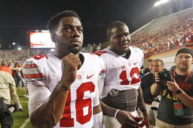 Ohio State quarterback J.T. Barrett (16) and teammate quarterback Cardale Jones (12) celebrate winning over Virginia Tech after an NCAA college football game in Blacksburg, Va., Monday, Sept. 7, 2015.  Ohio State won the game 42-24.  (AP Photo/Steve Helber)