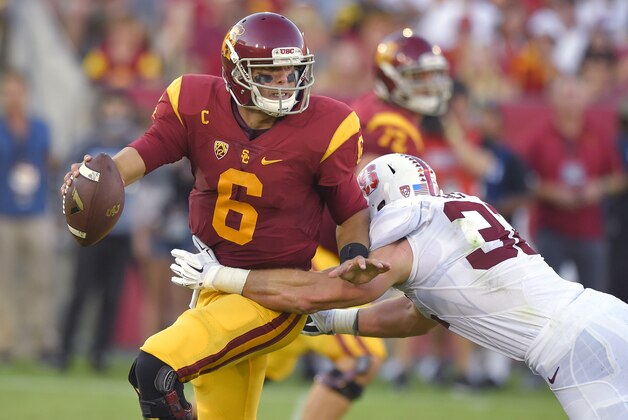 Southern California quarterback Cody Kessler, left, escapes a tackle by Stanford linebacker Joey Alfieri during the first half of an NCAA college football game, Saturday, Sept. 19, 2015, in Los Angeles. (AP Photo/Mark J. Terrill)