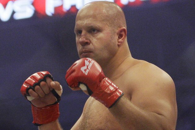 FILE - In this June 26, 2010, file photo, Fedor Emelianenko, of Russia, fights Fabricio Werdum in a Strikeforce/M-1 Global mixed martial arts match in San Jose, Calif. Emelianenko doesn't speak a lick of English. He rarely smiles. When he steps inside a ring or cage, he looks like he's bored, like he'd rather be reading a book. Here's why fans wait hours to see him, though: He just may be the best heavyweight fighter ever. (AP Photo/Jeff Chiu, File)