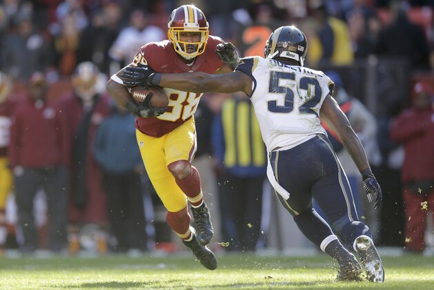 Washington Redskins wide receiver Pierre Garcon (88) carries the ball past St. Louis Rams outside linebacker Alec Ogletree (52) during the first half of an NFL football game in Landover, Md., Sunday, Dec. 7, 2014. (AP Photo/Patrick Semansky)