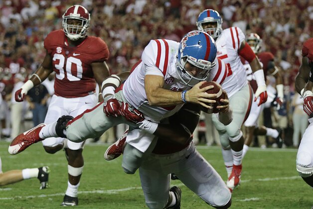 Mississippi quarterback Chad Kelly dives in for a touchdown against Alabama linebacker Shaun Hamilton during first half of an NCAA college football game, Saturday, Sept. 19, 2015, in Tuscaloosa, Ala. (AP Photo/Butch Dill)