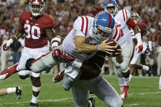 Mississippi quarterback Chad Kelly dives in for a touchdown against Alabama linebacker Shaun Hamilton during first half of an NCAA college football game, Saturday, Sept. 19, 2015, in Tuscaloosa, Ala. (AP Photo/Butch Dill)