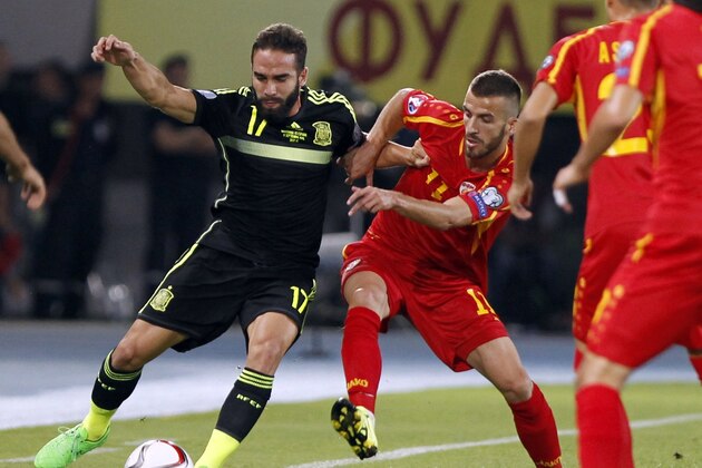 Spain's Dani Carvajal, left, controls the ball as Macedonia's Feran Hasani makes a challenge during the Euro 2016 qualifying match between Macedonia and Spain at the Philip II stadium, in Skopje, Tuesday, Sept. 8, 2015. (AP Photo/Vlatko Perkovski)