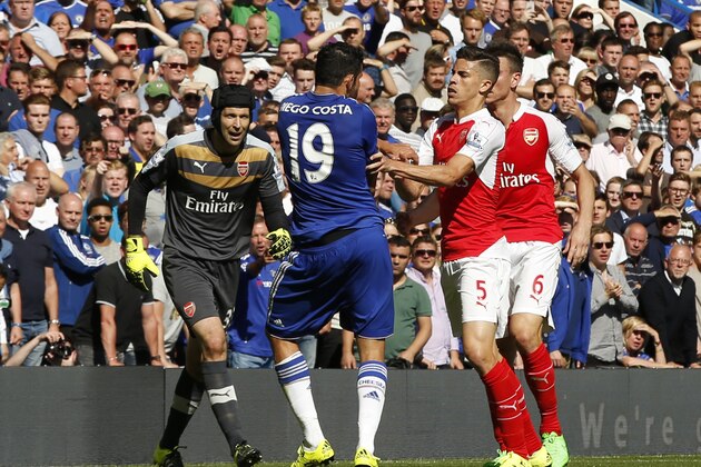 Arsenal's Gabriel, No 5, reacts and puts his arms onto Chelsea's Diego Costa, No 19, during the English Premier League soccer match between Chelsea and Arsenal at Stamford Bridge stadium in London, Saturday, Sept. 19, 2015. Both players were show a yellow card for the incident, with Gabriel being sent off for a further clash between the two player- Chelsea went onto win the game 2-0.(AP Photo/Alastair Grant)