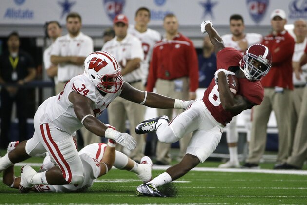 Alabama wide receiver Robert Foster (8) catches a pass against Wisconsin defensive end Chikwe Obasih (34) and linebacker Vince Biegel (47) during the first half of an NCAA college football game Saturday, Sept. 5, 2015, in Arlington, Texas. (AP Photo/LM Otero) Alabama wide receiver Robert Foster (8) catches a pass against Wisconsin defensive end Chikwe Obasih (34) and linebacker Vince Biegel (47) during the first half of an NCAA college football game Saturday, Sept. 5, 2015, in Arlington, Texas. (AP Photo/LM Otero)