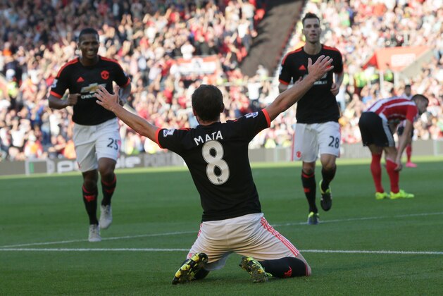Manchester United’s Juan Mata celebrates after scoring a goal, with Manchester United’s Luis Antonio Valencia, left, and Manchester United’s Morgan Schneiderlin, right, during the English Premier League soccer match between Southampton and Manchester United at St Mary's Stadium in Southampton, England, Sunday, Sept. 20, 2015. (AP Photo/Tim Ireland)