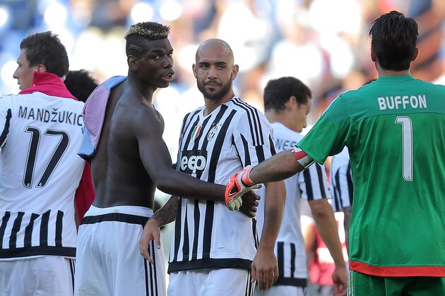 Juventus' French midfielder Paul Pogba (2ndL) looks on during the Italian Serie A football match Genoa vs Juventus on September 20, 2015 at 'Luigi Ferraris Stadium' in Genoa. AFP PHOTO / MARCO BERTORELLO        (Photo credit should read MARCO BERTORELLO/AFP/Getty Images)
