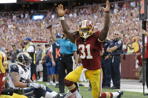 Washington Redskins running back Matt Jones (31) celebrates his touchdown as St. Louis Rams middle linebacker James Laurinaitis (55) sits in the end zone during the second half of an NFL football game in Landover, Md., Sunday, Sept. 20, 2015. (AP Photo/Patrick Semansky)
