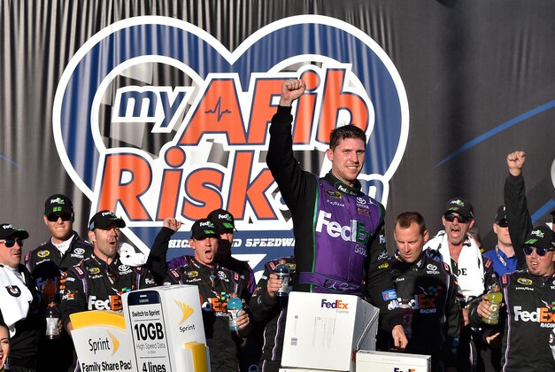 Sep 20, 2015; Joliet, IL, USA; NASCAR Sprint Cup Series driver Denny Hamlin celebrates in victory lane after winning the MyAFibRisk.com 400 at Chicagoland Speedway. Mandatory Credit: Jasen Vinlove-USA TODAY Sports