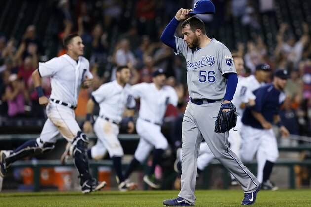 Kansas City Royals pitcher Greg Holland (56) walks off the field after giving up a game-winning RBI single to Detroit Tigers' Dixon Machado during the 12th inning of a baseball game Friday, Sept. 18, 2015, in Detroit. The Tigers defeated the Royals 5-4. (AP Photo/Duane Burleson)