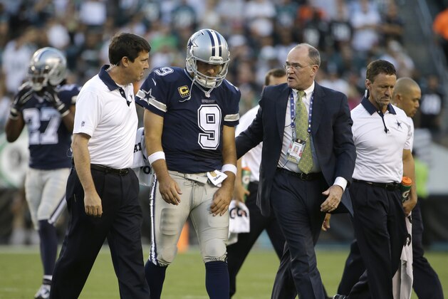 Dallas Cowboys' Tony Romo is helped off the field after an injury during the second half of an NFL football game against the Philadelphia Eagles, Sunday, Sept. 20, 2015, in Philadelphia. (AP Photo/Matt Rourke)