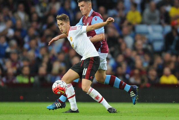 Manchester United’s Adnan Januzaj, front holds back Aston Villa’s Ashley Westwood during the English Premier League soccer match between Aston Villa and Manchester United at Villa Park, Birmingham, England, Friday, Aug. 14, 2015. (AP Photo/Rui Vieira)