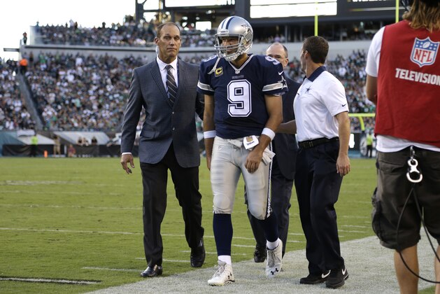 Dallas Cowboys' Tony Romo is helped off the field after an injury during the second half of an NFL football game against the Philadelphia Eagles, Sunday, Sept. 20, 2015, in Philadelphia. (AP Photo/Matt Rourke)