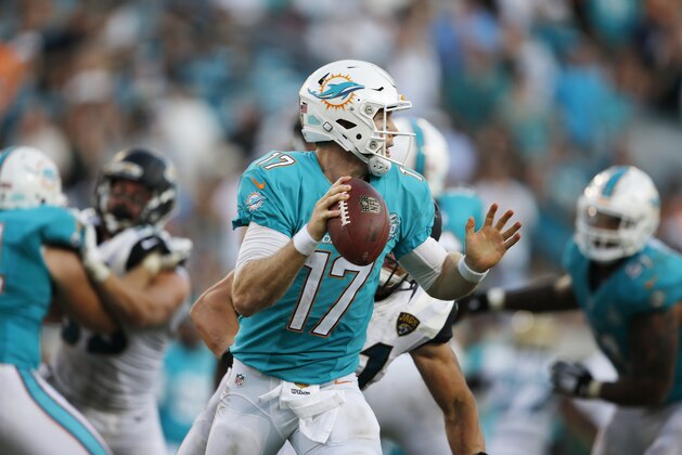 Miami Dolphins quarterback Ryan Tannehill (17) works against the Jacksonville Jaguars during the second half of an NFL football game, Sunday, Sept. 20, 2015, in Jacksonville, Fla. (AP Photo/Stephen B. Morton)