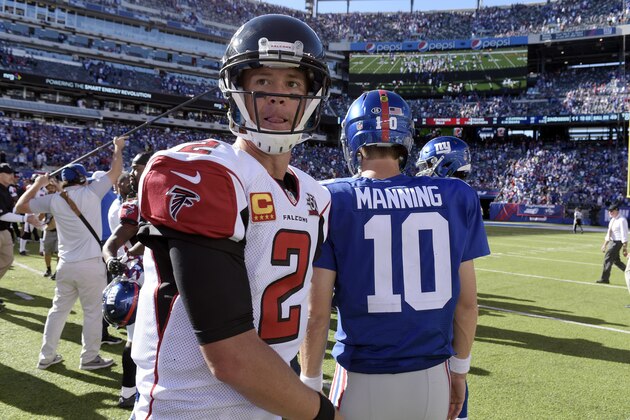 Atlanta Falcons quarterback Matt Ryan, left, walks on the field after talking to New York Giants quarterback Eli Manning after an NFL football game, Sunday, Sept. 20, 2015, in East Rutherford, N.J. The Falcons won 24-20. (AP Photo/Bill Kostroun)