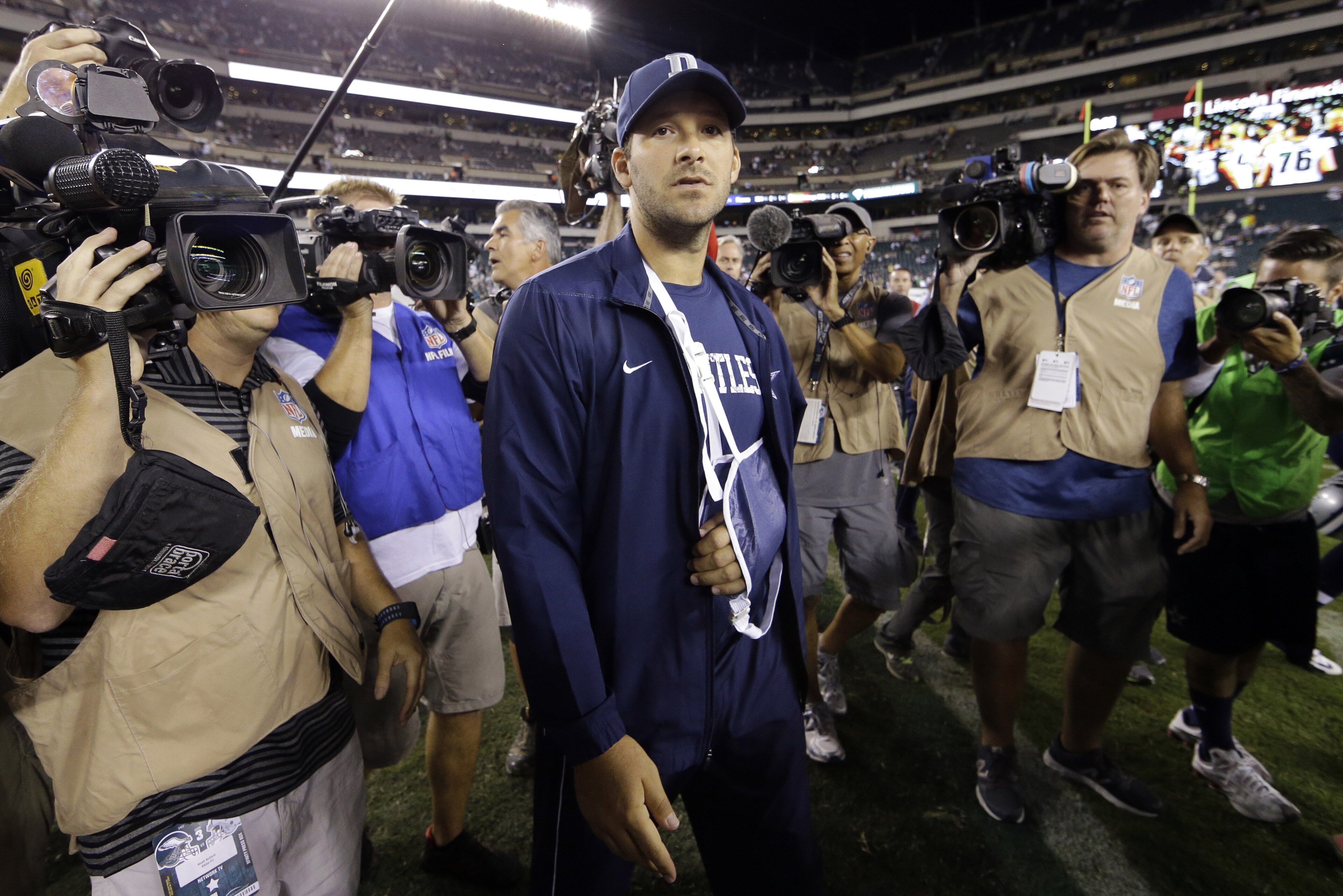 Injured Dallas Cowboys quarterback Tony Romo walks the field after an NFL football game against the Philadelphia Eagles, Sunday, Sept. 20, 2015, in Philadelphia. Dallas won 20-10. (AP Photo/Matt Rourke)