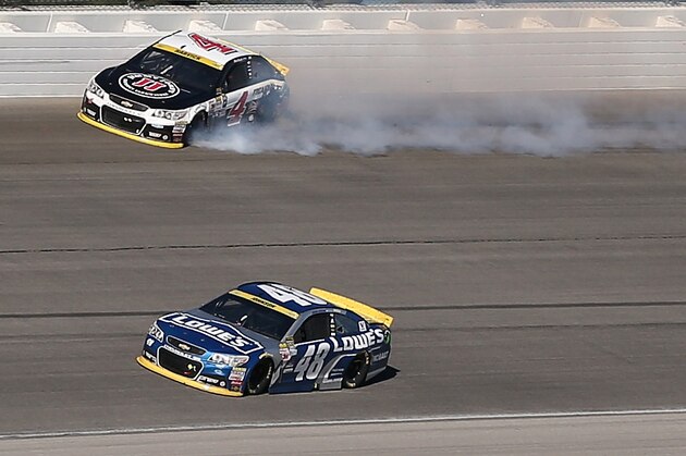 JOLIET, IL - SEPTEMBER 20:  Kevin Harvick, driver of the #4 Jimmy John's / Budweiser Chevrolet, spins after contact with Jimmie Johnson, driver of the #48 Lowe's Chevrolet, during the NASCAR Sprint Cup Series myAFibRisk.com 400 at Chicagoland Speedway on September 20, 2015 in Joliet, Illinois.  (Photo by Jonathan Daniel/Getty Images)