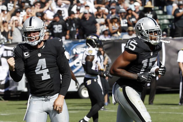 Oakland Raiders' Derek Carr (4) celebrates after throwing a touchdown pass to Michael Crabtree, right, during the second half of an NFL football game Sunday, Sept. 20, 2015, in Oakland , Calif. (AP Photo/Tony Avelar)