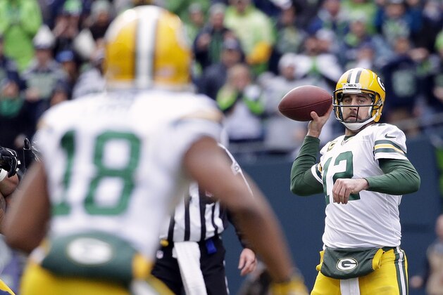 Green Bay Packers' Aaron Rodgers (12) looks to pass to Randall Cobb (18) during the first half of the NFL football NFC Championship game against the Seattle Seahawks Sunday, Jan. 18, 2015, in Seattle. (AP Photo/Elaine Thompson)
