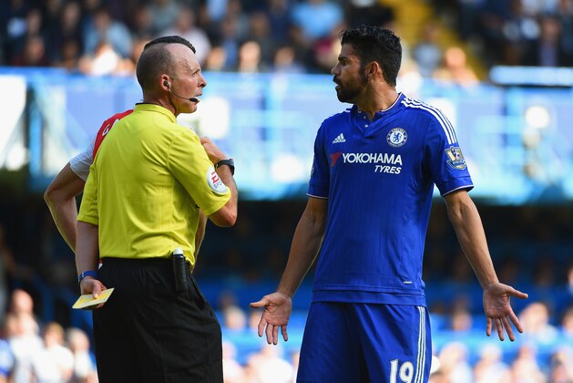 LONDON, ENGLAND - SEPTEMBER 19:  Diego Costa of Chelsea is shown a yellow card by referee Mike Dean during the Barclays Premier League match between Chelsea and Arsenal at Stamford Bridge on September 19, 2015 in London, United Kingdom.  (Photo by Ross Kinnaird/Getty Images)