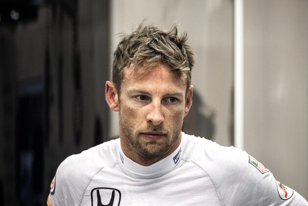 McLaren Honda's British driver Jenson Button is seen in the garage during the free practice session of the Formula One Singapore Grand Prix in Singapore on September 18, 2015. AFP PHOTO / Philippe Lopez        (Photo credit should read PHILIPPE LOPEZ/AFP/Getty Images)