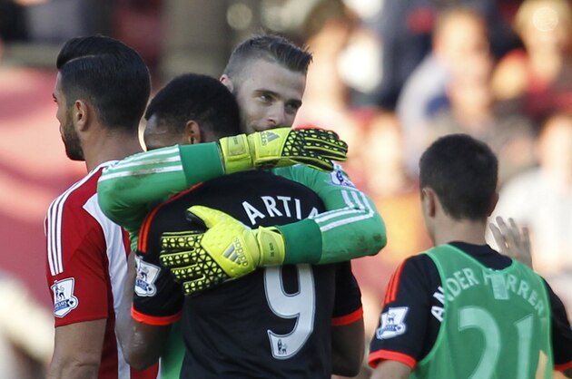 Manchester United's Spanish goalkeeper David de Gea embraces Manchester United's French striker Anthony Martial (2nd L) after the English Premier League football match between Southampton and Manchester United at St Mary's Stadium in Southampton, southern England on September 20, 2015. Manchester United won the game 3-2. AFP PHOTO / IAN KINGTON

RESTRICTED TO EDITORIAL USE. No use with unauthorized audio, video, data, fixture lists, club/league logos or 'live' services. Online in-match use limited to 75 images, no video emulation. No use in betting, games or single club/league/player publications.        (Photo credit should read IAN KINGTON/AFP/Getty Images)