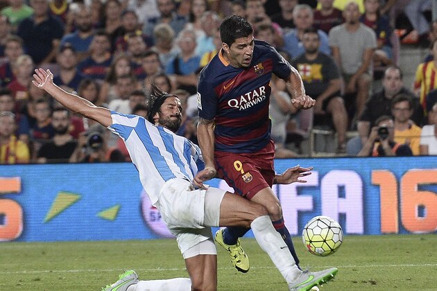 Barcelona's Uruguayan forward Luis Suarez (R) vies with Malaga's defender Argentinian Marcos Angeleri during the Spanish league football match FC Barcelona vs Malaga CF at the Camp Nou stadium in Barcelona on August 29, 2015.   AFP PHOTO/ JOSEP LAGO        (Photo credit should read JOSEP LAGO/AFP/Getty Images)