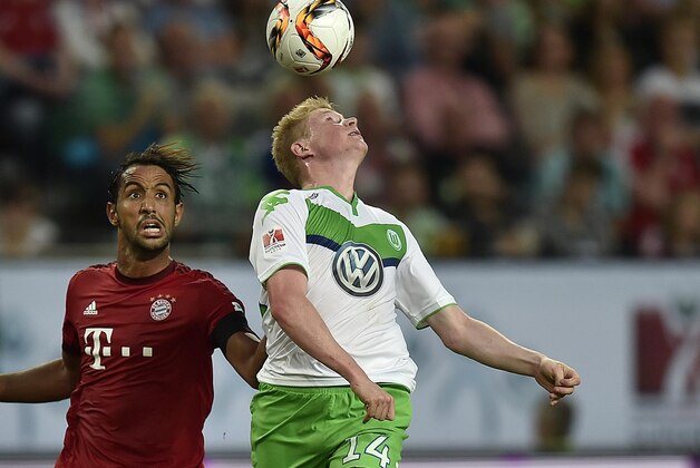 Wolfburg's Kevin De Bruyne from Belgium, right, and Bayern’s Medhi Benatia from Morocco challenge for the ball during the German Supercup final soccer match between VfL Wolfsburg and Bayern Munich in Wolfsburg, Germany, Saturday, Aug. 1, 2015. (AP Photo/Martin Meissner)