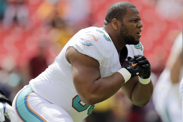 Miami Dolphins defensive tackle Ndamukong Suh (93) warms up before an NFL football game against the Washington Redskins, Sunday, Sept. 13, 2015, in Landover, Md. (AP Photo/Mark Tenally)