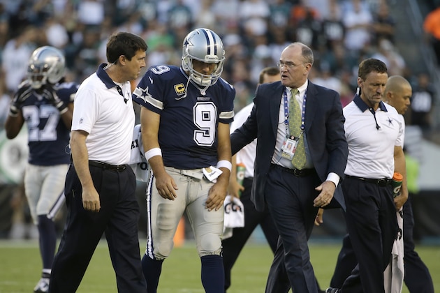 Dallas Cowboys' Tony Romo is helped off the field after an injury during the second half of an NFL football game against the Philadelphia Eagles, Sunday, Sept. 20, 2015, in Philadelphia. (AP Photo/Matt Rourke)
