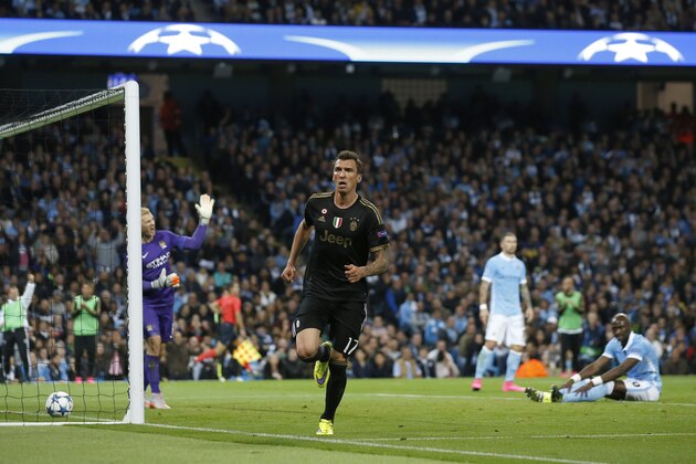 Juventus' Mario Mandzukic  celebrates after scoring a goal during the Champions League group D soccer match between Manchester City and Juventus at the Etihad Stadium, Manchester, England, Tuesday, Sept. 15, 2015. (AP Photo/Jon Super)
