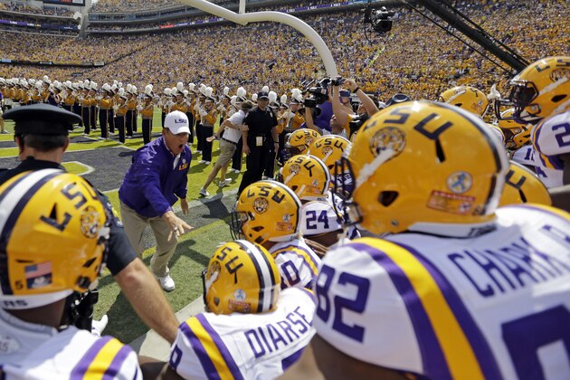 LSU head coach Les Miles leads his team onto the field before an NCAA college football game against Auburn in Baton Rouge, La., Saturday, Sept. 19, 2015. (AP Photo/Gerald Herbert)
