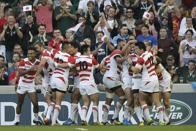 Japan celebrate a try from Ayumu Goromaru during the Rugby World Cup Pool B match between South Africa and Japan at the Brighton Community Stadium, Brighton, England Saturday, Sept. 19, 2015. (AP Photo/Tim Ireland)