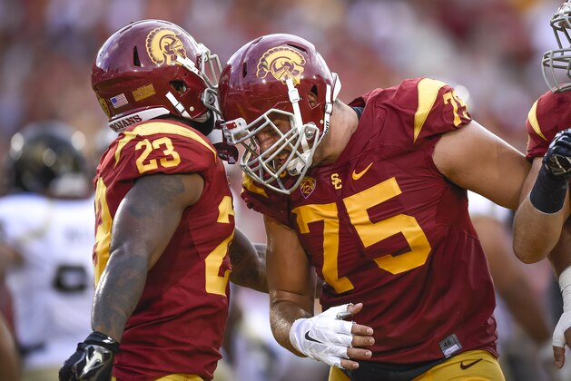 Southern California center Max Tuerk (75) celebrates teammate Southern California running back Tre Madden (23) touchdown during the first half of an NCAA college football game against Idaho, Saturday, Sept. 12, 2015, in Los Angeles. (AP Photo/Gus Ruelas)