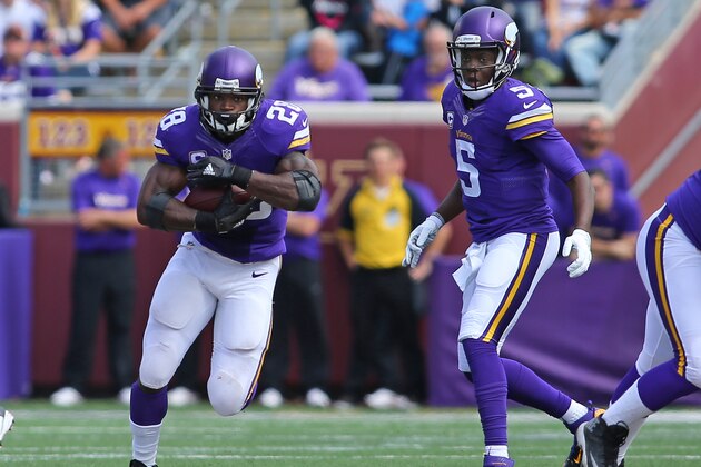 MINNEAPOLIS, MN - SEPTEMBER 20: Adrian Peterson #28 carries the ball while Teddy Bridgewater #5 of the Minnesota Vikings watches in the third quarter against the Detroit Lions at TCF Bank Stadium on September 20, 2015 in Minneapolis, Minnesota. (Photo by Adam Bettcher/Getty Images)