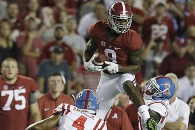 Alabama wide receiver Robert Foster (8) catches the ball against Mississippi linebacker Denzel Nkemdiche (4) and another defender during first half of an NCAA football game, Saturday, Sept. 19, 2015, in Tuscaloosa, Ala. (AP Photo/Butch Dill)