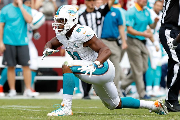 Sep 13, 2015; Landover, MD, USA; Miami Dolphins defensive end Cameron Wake (91) celebrates after a sack against the Washington Redskins at FedEx Field. Mandatory Credit: Geoff Burke-USA TODAY Sports