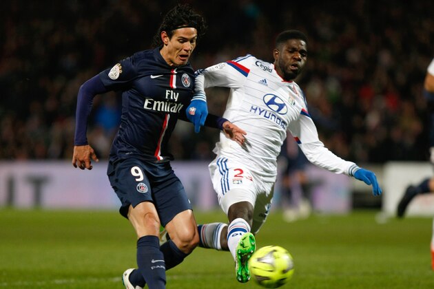 Paris Saint Germain's Uruguayan forward Edinson Cavani, left, challenges for the ball with Lyon's French defender Samuel Umtiti, during the League One soccer match between Lyon and Paris Saint-Germain, at the Gerland Stadium, in Lyon, central France, Sunday Feb. 8, 2015. (AP Photo/Claude Paris)